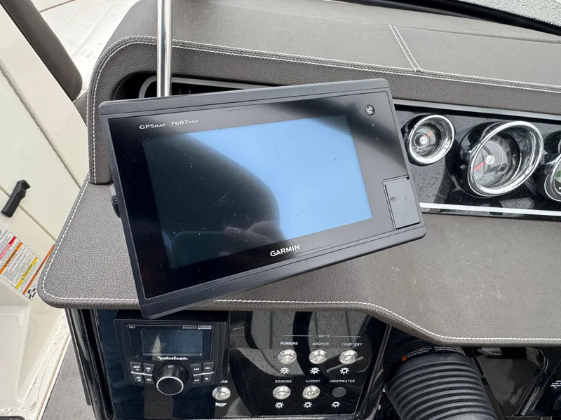 Slide: The Image of Garmin GPS on 2017 Sea Ray SLX 230 boat dashboard with control panel and gauges. - 9