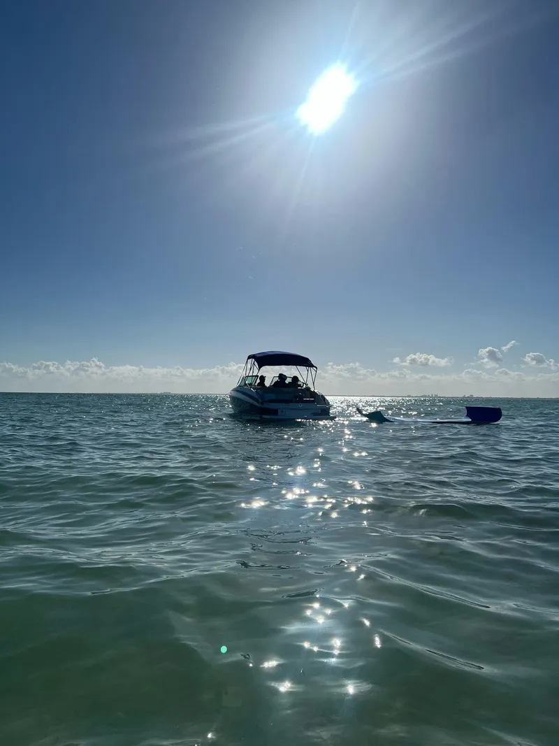 Slide: The Image of 2013 Regal 24 FasDeck boat on sunny ocean waters. - 11