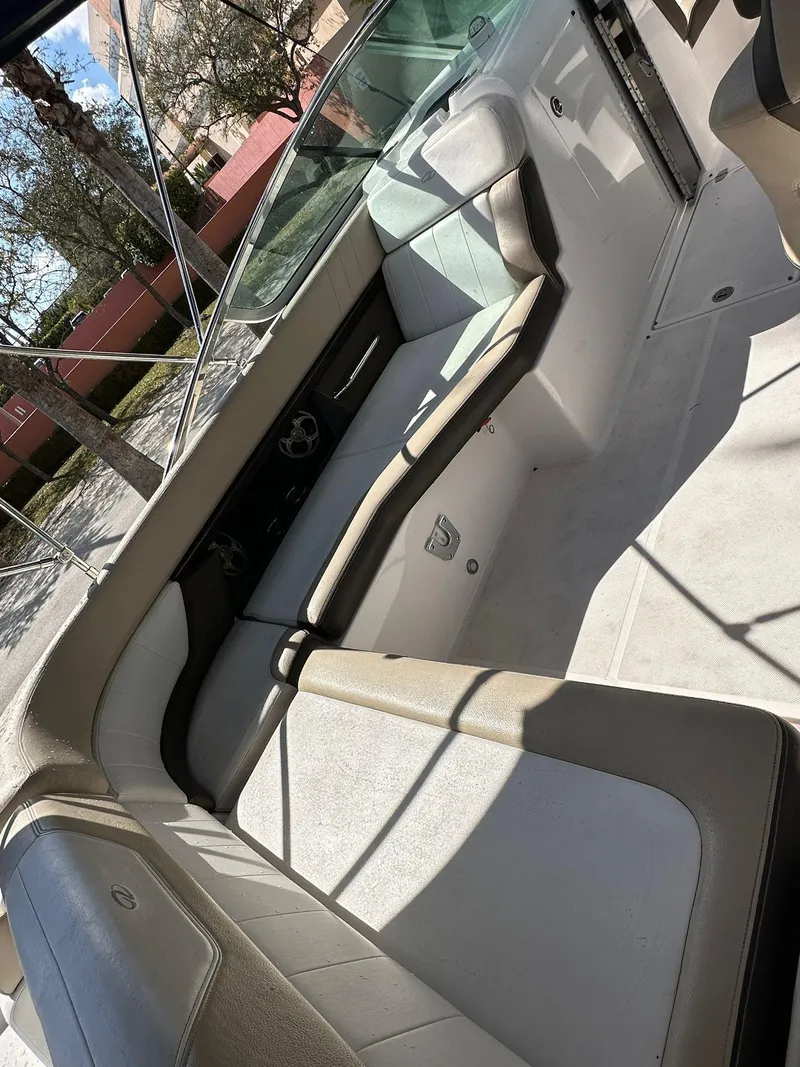 Slide: The Image of 2013 Regal 24 FasDeck boat interior with beige seating and steering wheel. - 13