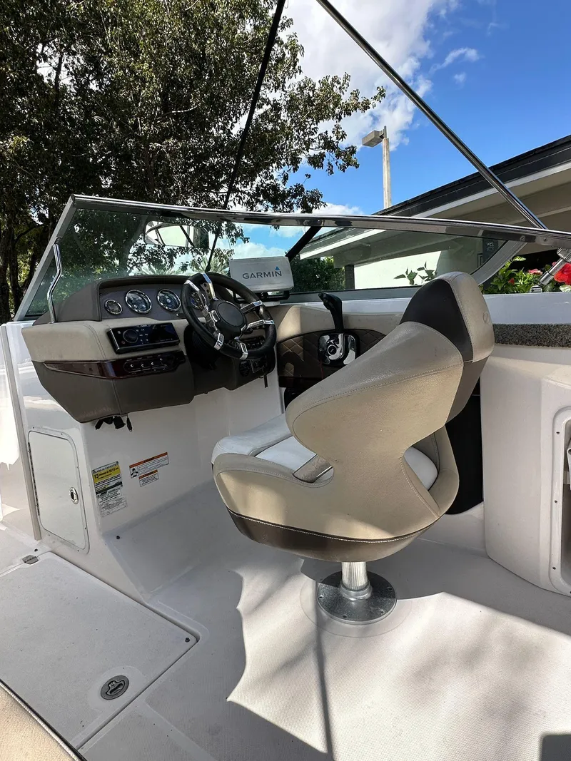Slide: The Image of 2013 Regal 24 FasDeck boat cockpit with steering wheel and captain's chair. - 15