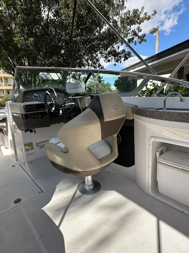 Slide: The Image of 2013 Regal 24 FasDeck boat interior with captain's chair and steering wheel. - 2