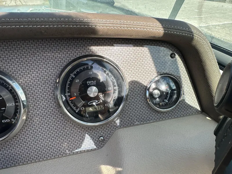 Slide: The Image of Dashboard of a 2013 Regal 24 FasDeck boat with RPM and fuel gauges. - 4