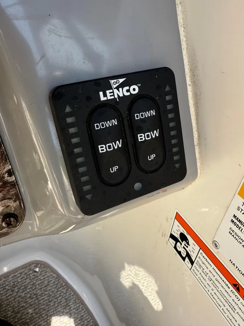 Slide: The Image of Lenco trim tab control panel on 2013 Stingray 235 CR boat. - 10