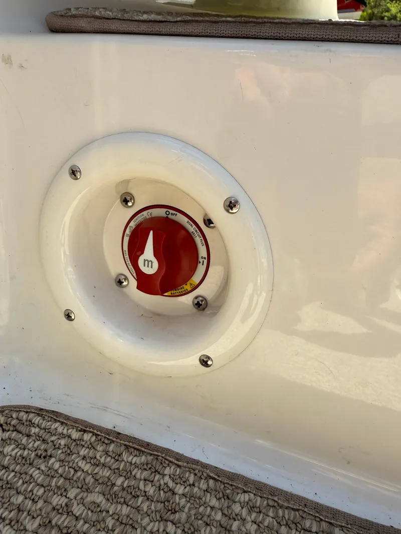 Slide: The Image of 2013 Stingray 235 CR boat battery switch on white panel. - 12