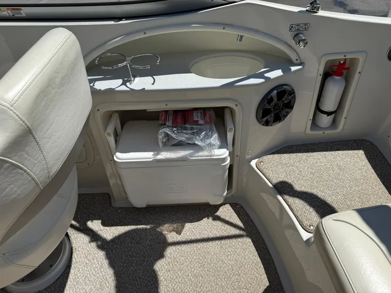 Slide: The Image of Interior of a 2013 Stingray 235 CR boat with seating, cooler, and fire extinguisher. - 13