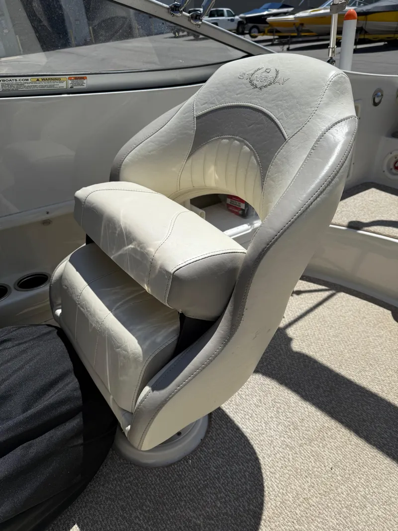 Slide: The Image of 2013 Stingray 235 CR boat seat with white leather upholstery and embossed logo. - 14