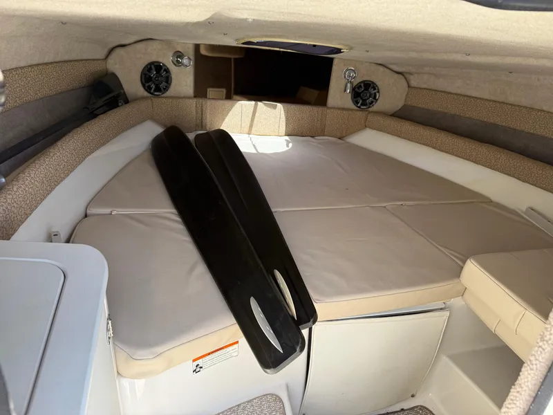 Slide: The Image of 2013 Stingray 235 CR cabin interior with beige cushions and speakers. - 16