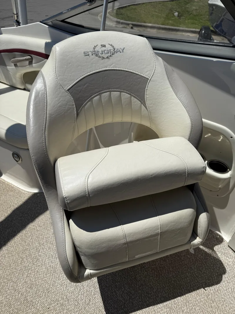 Slide: The Image of 2013 Stingray 235 CR boat seat with gray and white upholstery. - 18
