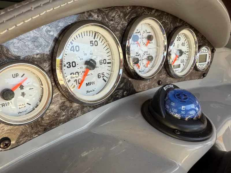 Slide: The Image of Dashboard of a 2013 Stingray 235 CR boat with gauges and compass. - 5