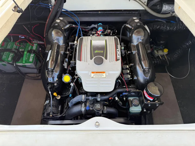 Slide: The Image of Engine compartment of a 2013 Stingray 235 CR boat, featuring a powerful motor setup. - 6