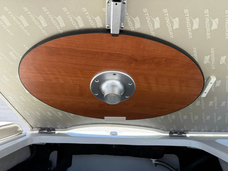 Slide: The Image of 2013 Stingray 235 CR boat interior with wooden table mount. - 7