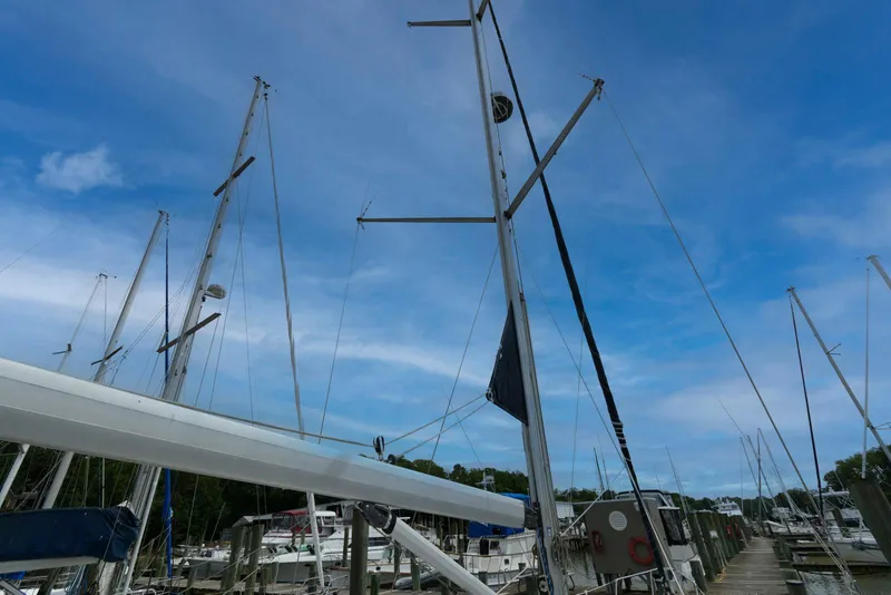 Slide: The Image of Hunter 44 Deck Salon sailboat, 2004 model, docked under a clear blue sky. - 12