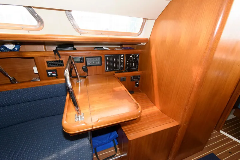 Slide: The Image of 2004 Hunter 44 Deck Salon interior with navigation station and wooden finish. - 18