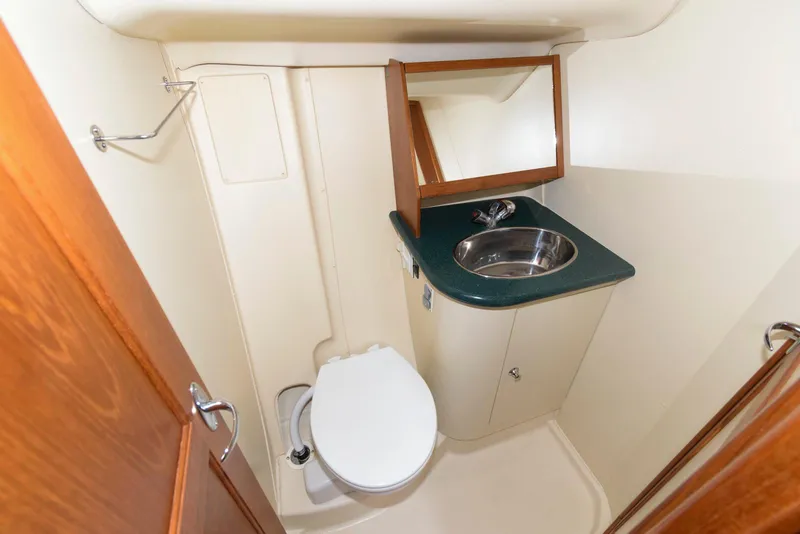 Slide: The Image of Compact bathroom in 2004 Hunter 44 Deck Salon yacht with sink and toilet. - 20