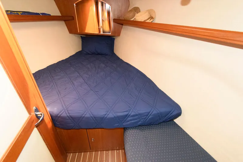 Slide: The Image of Cozy cabin interior of 2004 Hunter 44 Deck Salon with blue bedding. - 21