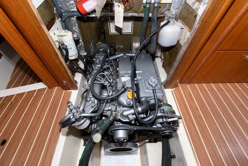 Slide: The Image of Engine compartment of 2004 Hunter 44 Deck Salon sailboat, showcasing detailed mechanical components. - 23