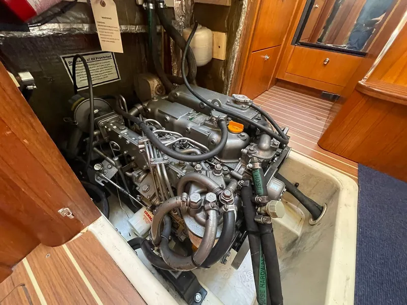 Slide: The Image of Engine compartment of 2004 Hunter 44 Deck Salon sailboat, showcasing detailed mechanical components. - 24