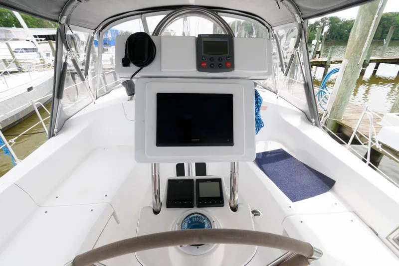 Slide: The Image of Cockpit of 2004 Hunter 44 Deck Salon sailboat with navigation equipment and steering wheel. - 5