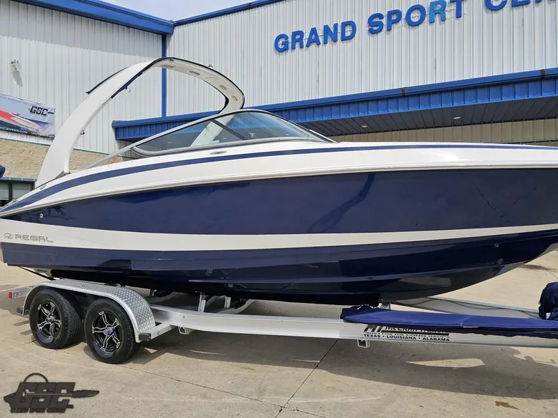 Slide: The Image of 2011 Regal 2500 Bowrider boat on trailer outside Grand Sport Center. - 16