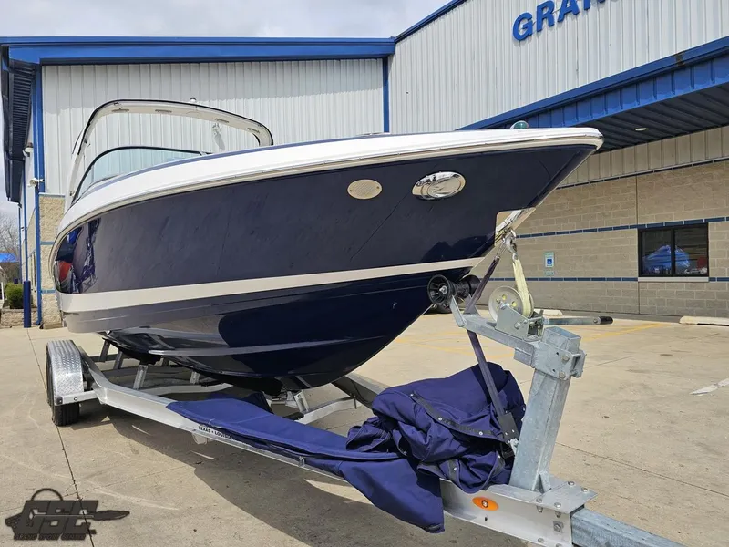 Slide: The Image of 2011 Regal 2500 Bowrider boat on trailer outside a building. - 18