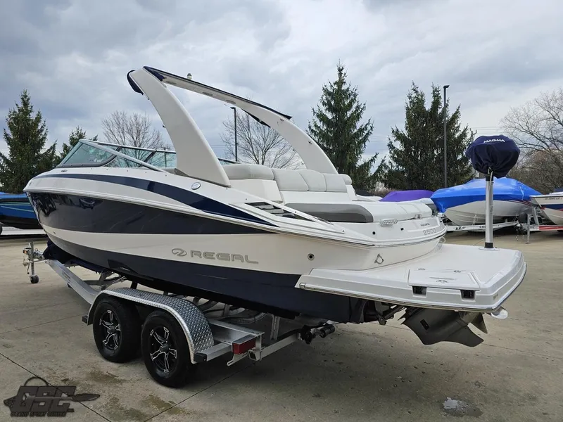 Slide: The Image of 2011 Regal 2500 Bowrider boat on trailer, parked outdoors, overcast sky. - 32