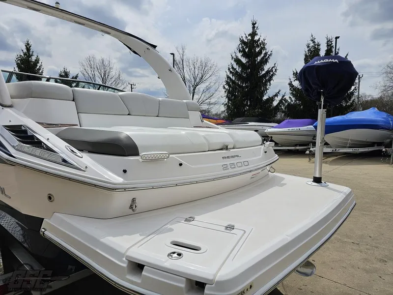 Slide: The Image of 2011 Regal 2500 Bowrider boat with spacious seating and sleek design, docked outdoors. - 33