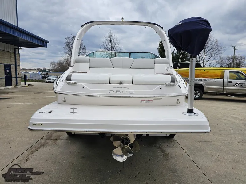 Slide: The Image of 2011 Regal 2500 Bowrider boat, rear view, parked outdoors on concrete surface. - 35
