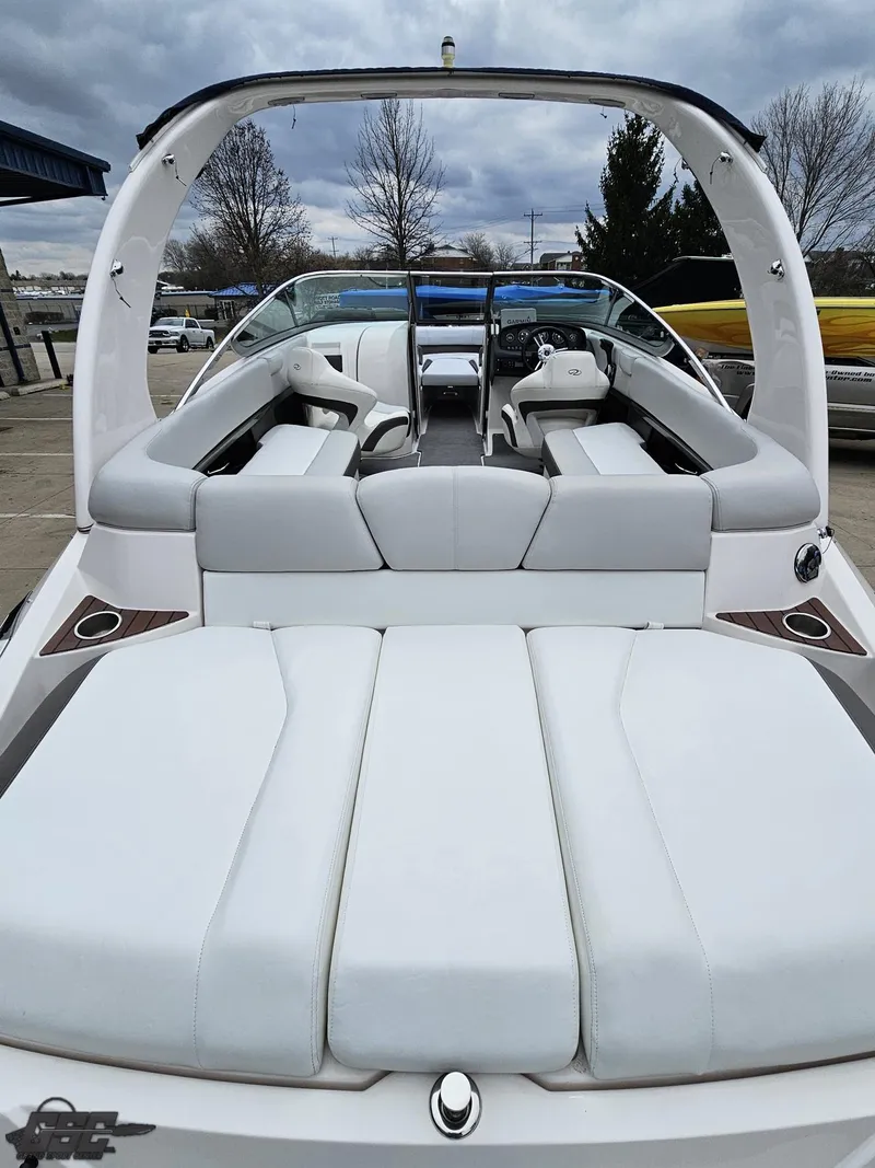 Slide: The Image of 2011 Regal 2500 Bowrider boat with sleek white seating and modern design. - 43