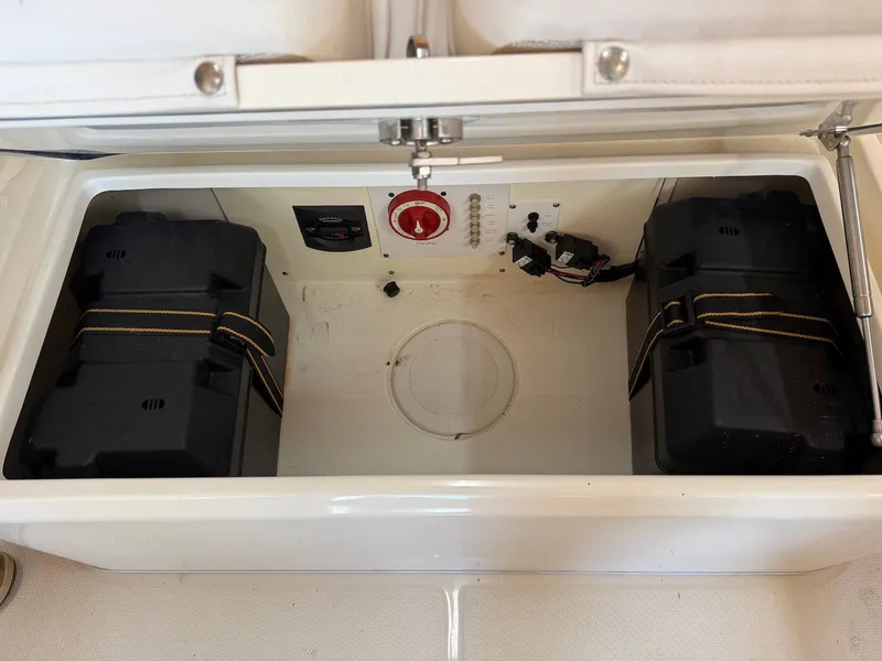 Slide: The Image of Battery compartment of 2012 Edgewater 245 CX boat, featuring dual battery setup. - 10