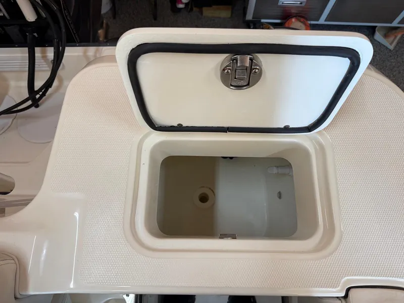 Slide: The Image of Open storage compartment on a 2012 Edgewater 245 CX boat. - 11