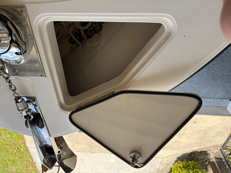 Slide: The Image of Open storage compartment on a 2012 Edgewater 245 CX boat, showing interior space. - 16