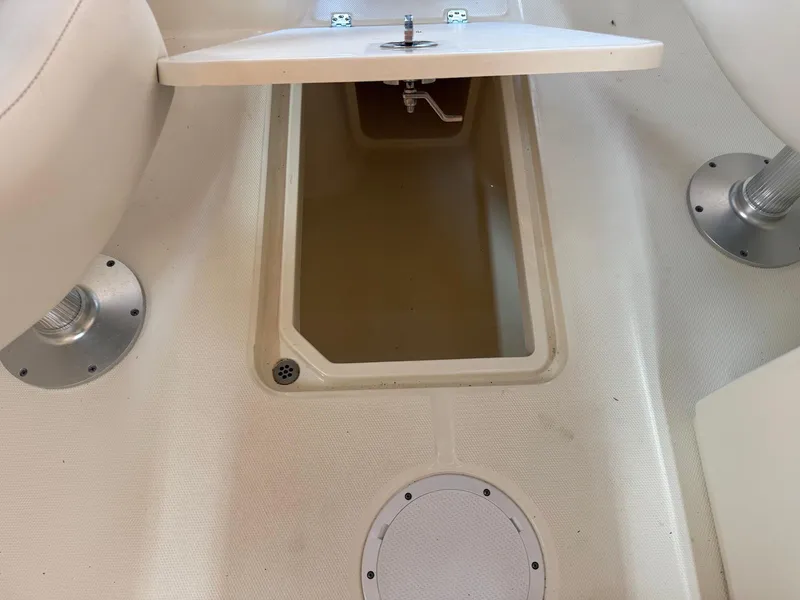 Slide: The Image of Open storage compartment on 2012 Edgewater 245 CX boat interior. - 19