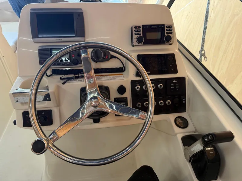 Slide: The Image of Steering console of 2012 Edgewater 245 CX boat with navigation and control systems. - 20