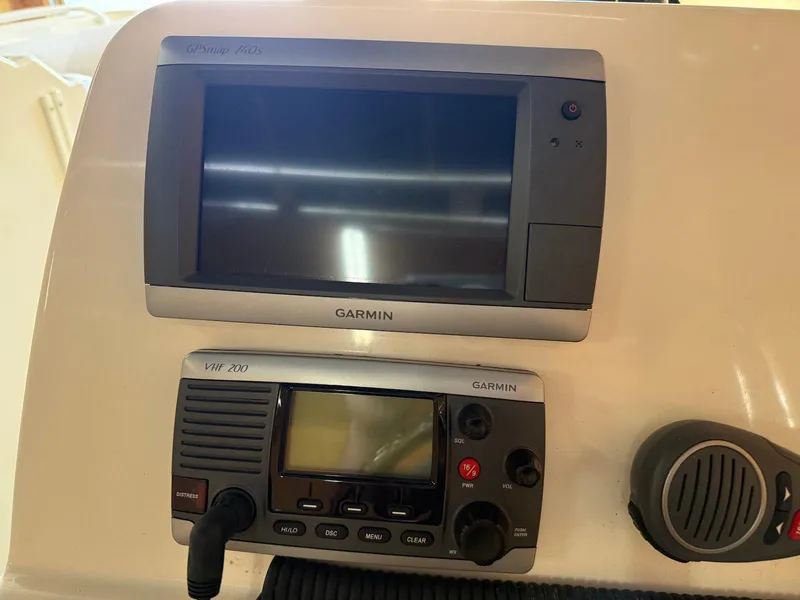 Slide: The Image of Garmin marine electronics on 2012 Edgewater 245 CX boat dashboard, featuring GPS and VHF radio. - 23