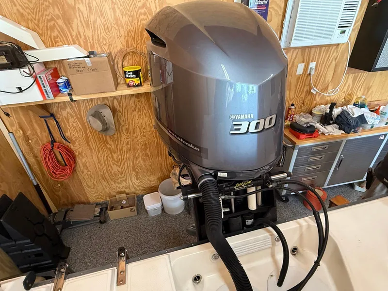 Slide: The Image of Yamaha 300 outboard motor on 2012 Edgewater 245 CX boat in a workshop setting. - 29