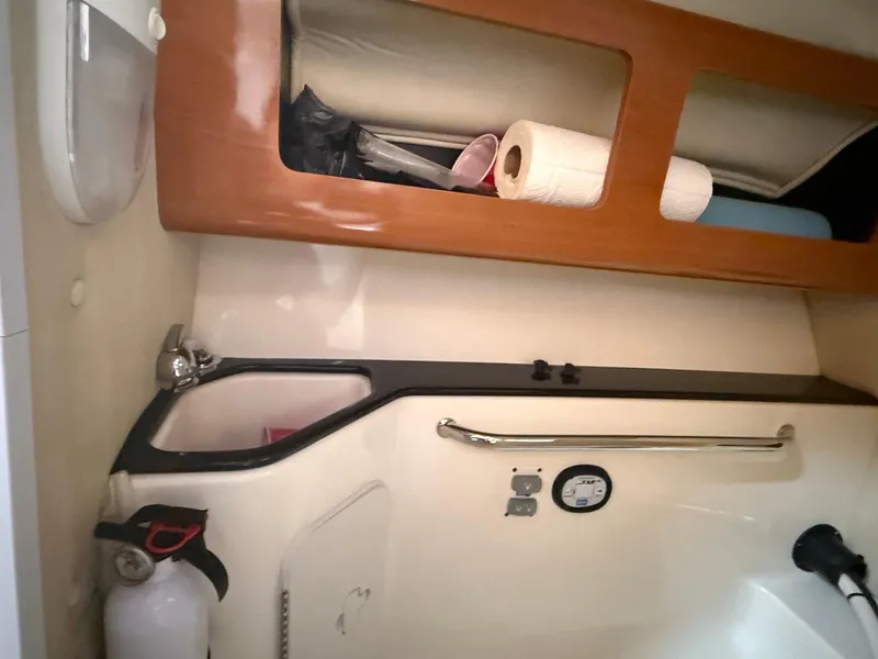 Slide: The Image of Interior of 2012 Edgewater 245 CX boat with storage and safety equipment. - 31