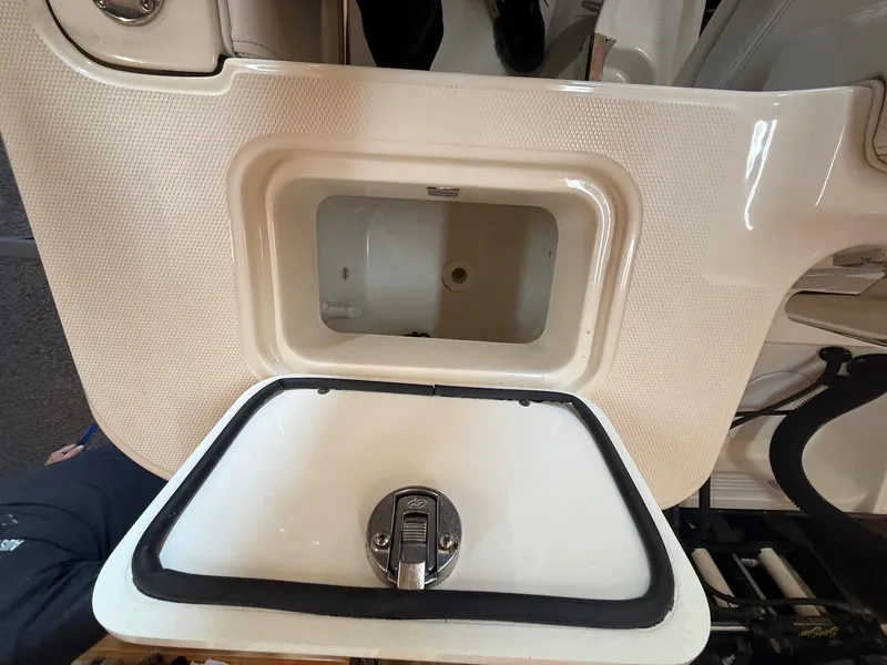 Slide: The Image of Edgewater 245 CX 2012 boat compartment with open hatch and latch. - 33