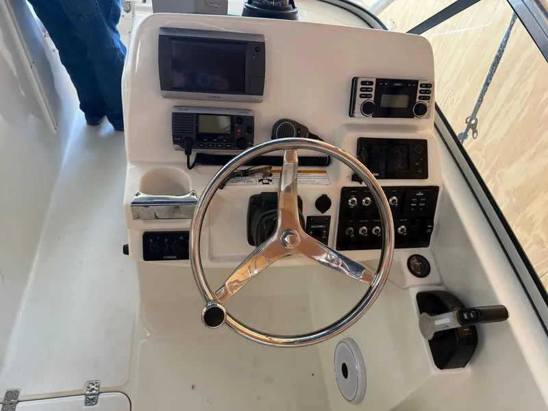Slide: The Image of Steering console of 2012 Edgewater 245 CX boat with navigation equipment and controls. - 5