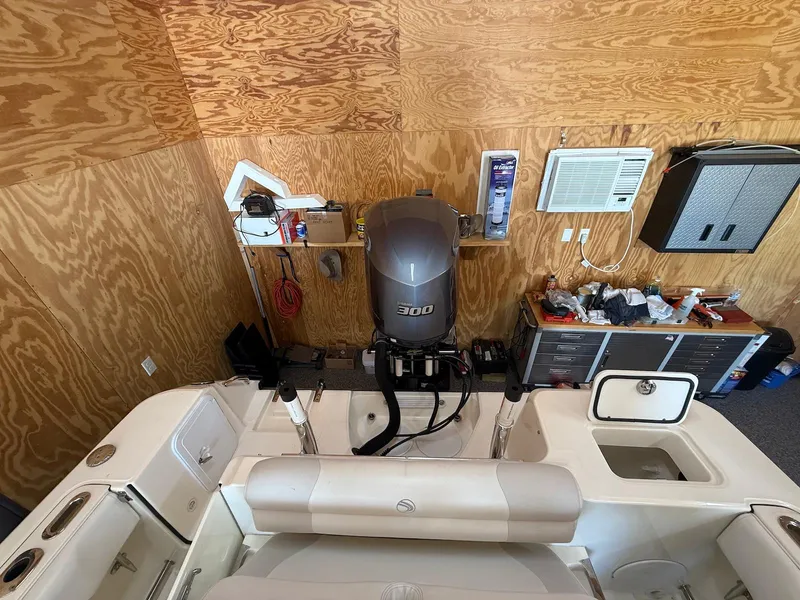 Slide: The Image of 2012 Edgewater 245 CX boat in garage with Yamaha 300 outboard motor. - 7