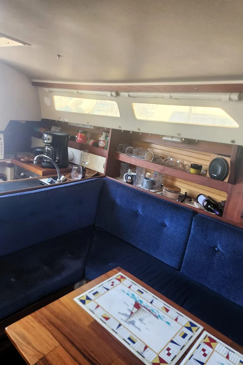 Slide: The Image of Interior of a 1987 Catalina 30 Mk II sailboat with cozy seating and nautical decor. - 14