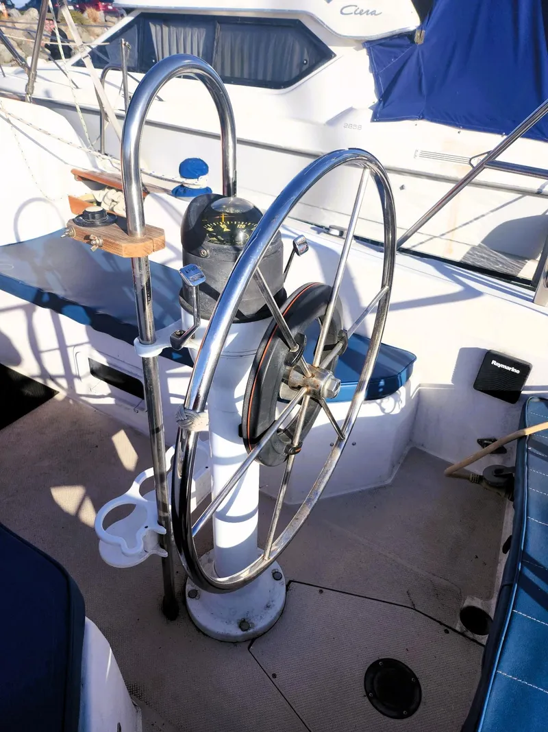 Slide: The Image of 1987 Catalina 30 Mk II sailboat cockpit with steering wheel and navigation equipment. - 19