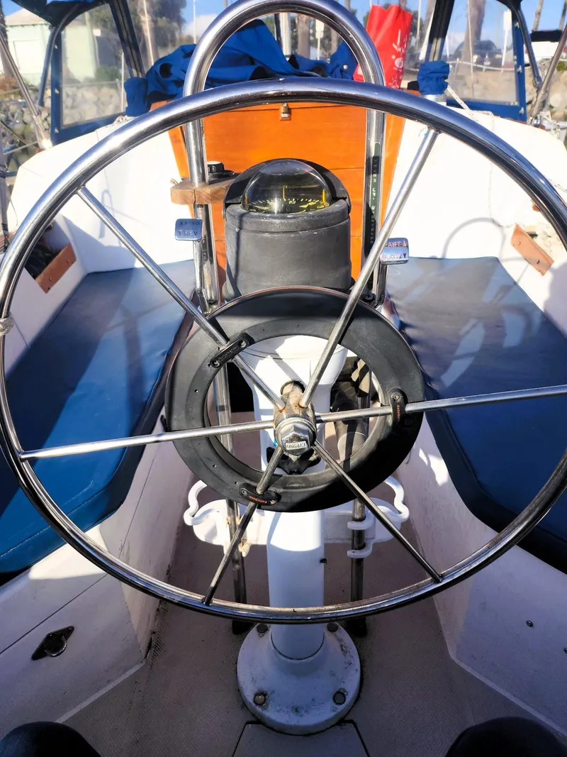 Slide: The Image of 1987 Catalina 30 Mk II sailboat cockpit with steering wheel and compass. - 20