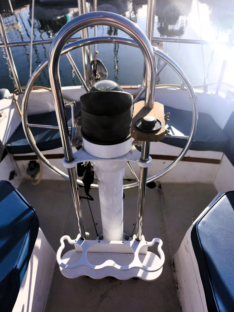 Slide: The Image of Steering wheel of a 1987 Catalina 30 Mk II sailboat, featuring a polished metal design. - 21
