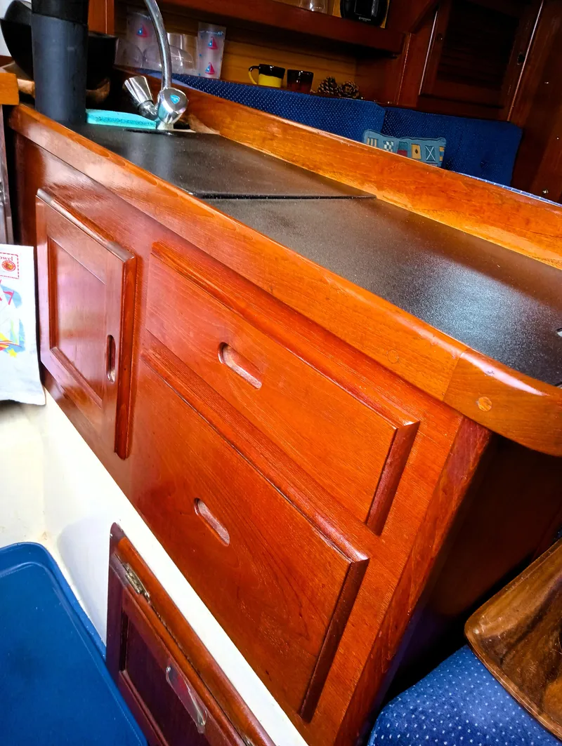 Slide: The Image of 1987 Catalina 30 Mk II galley with wooden cabinetry and sink. - 24