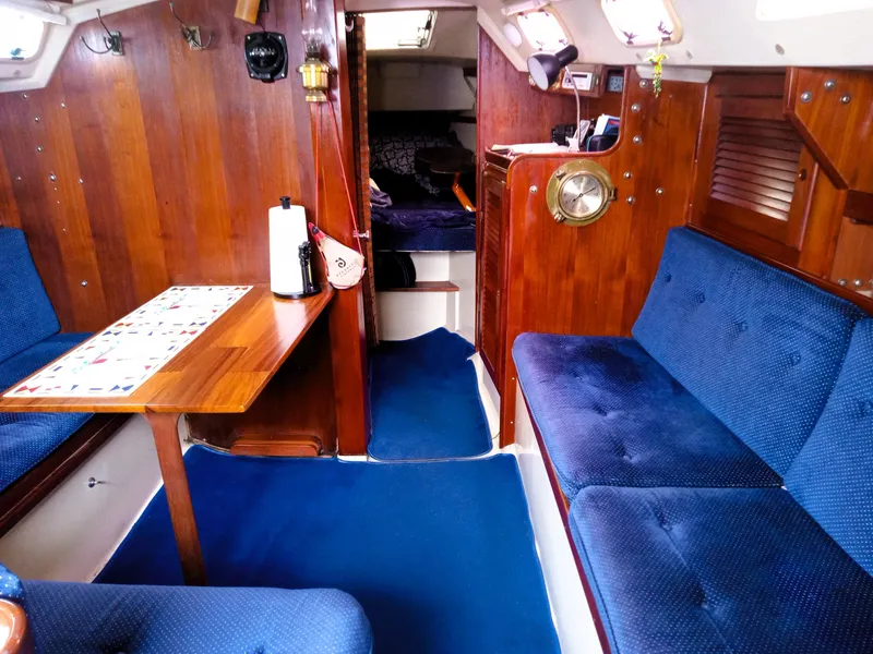 Slide: The Image of Interior of 1987 Catalina 30 Mk II sailboat with blue seating and wooden finishes. - 25