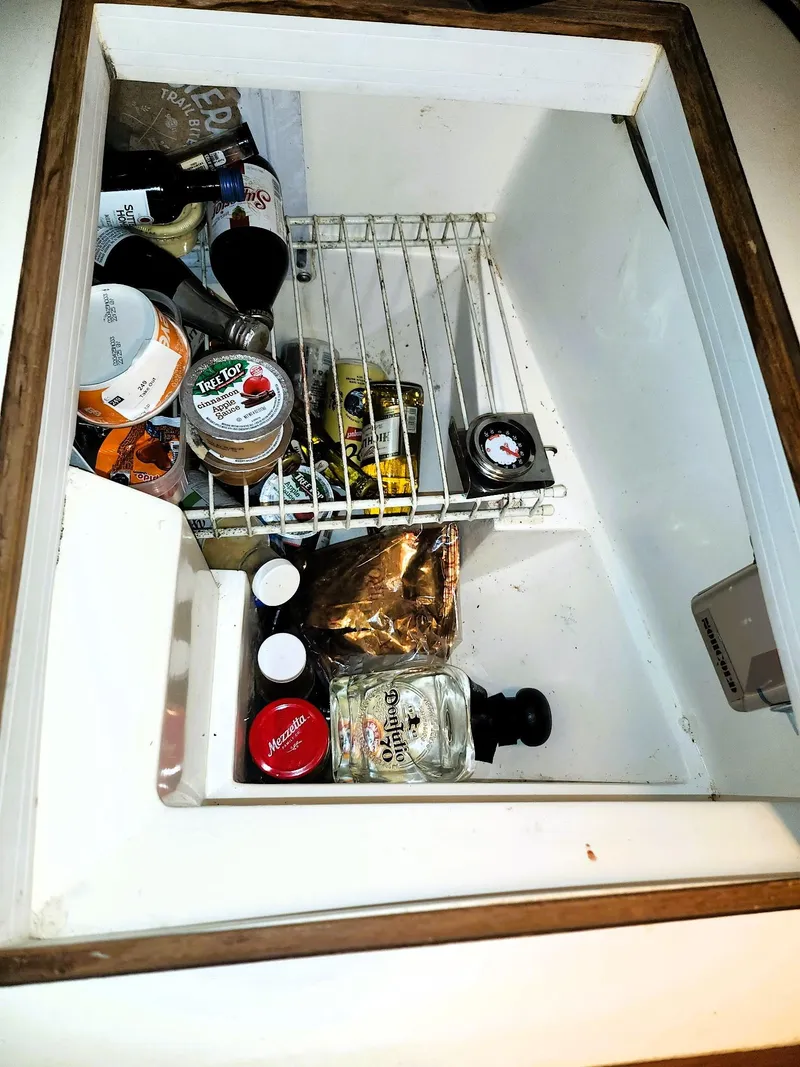Slide: The Image of Refrigerator interior of 1987 Catalina 30 Mk II sailboat with assorted food items. - 5