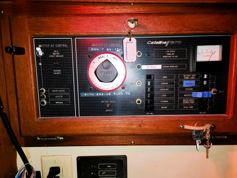 Slide: The Image of Electrical control panel of a 1987 Catalina 30 Mk II sailboat, featuring various switches and gauges. - 6