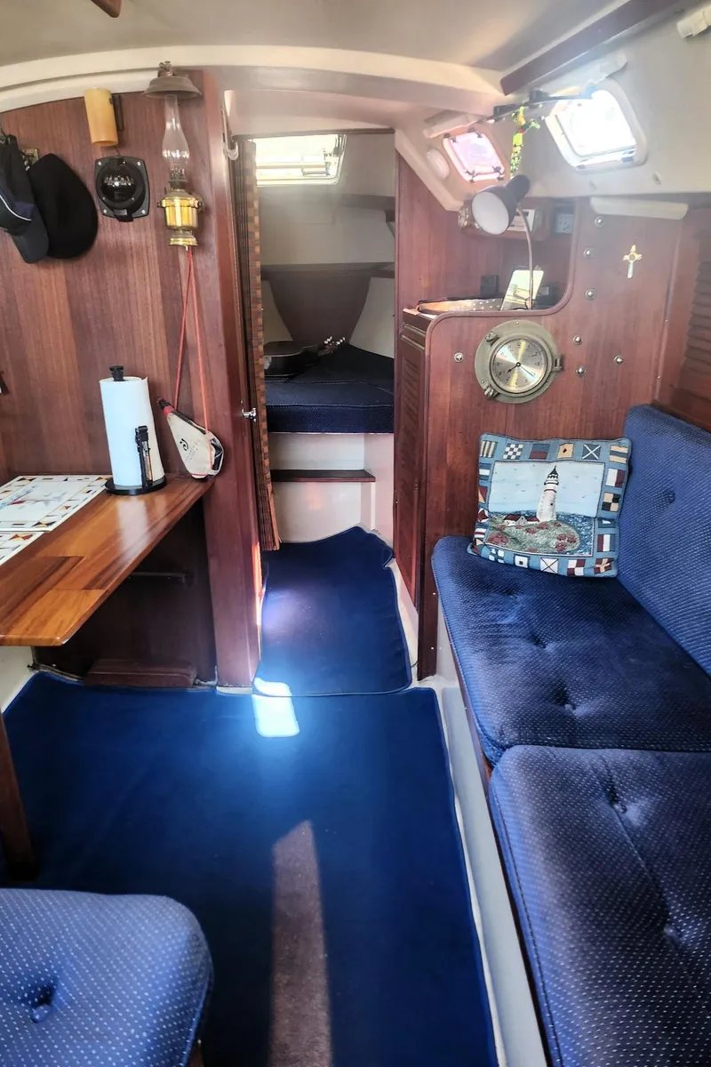 Slide: The Image of Interior of a 1987 Catalina 30 Mk II sailboat with blue upholstery and wooden accents. - 9