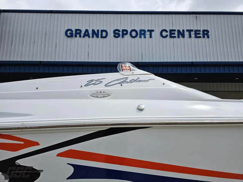 Slide: The Image of 2005 Baja 25 Outlaw boat at Grand Sport Center, showcasing sleek design and vibrant graphics. - 10