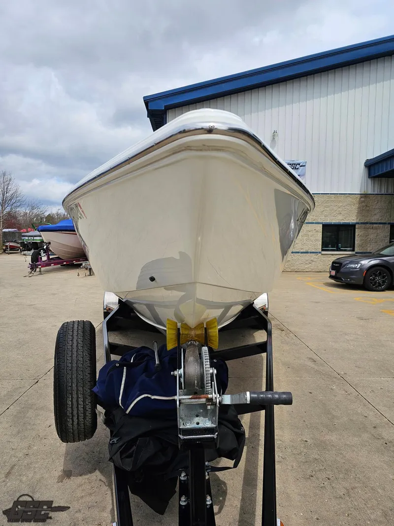 Slide: The Image of 2005 Baja 25 Outlaw boat on trailer, parked outside a building. - 15